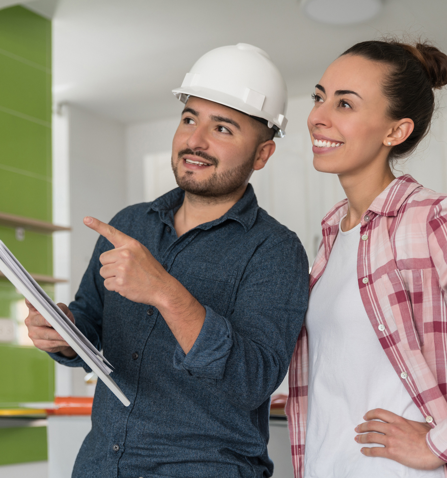 Construction worker discussing plans with woman