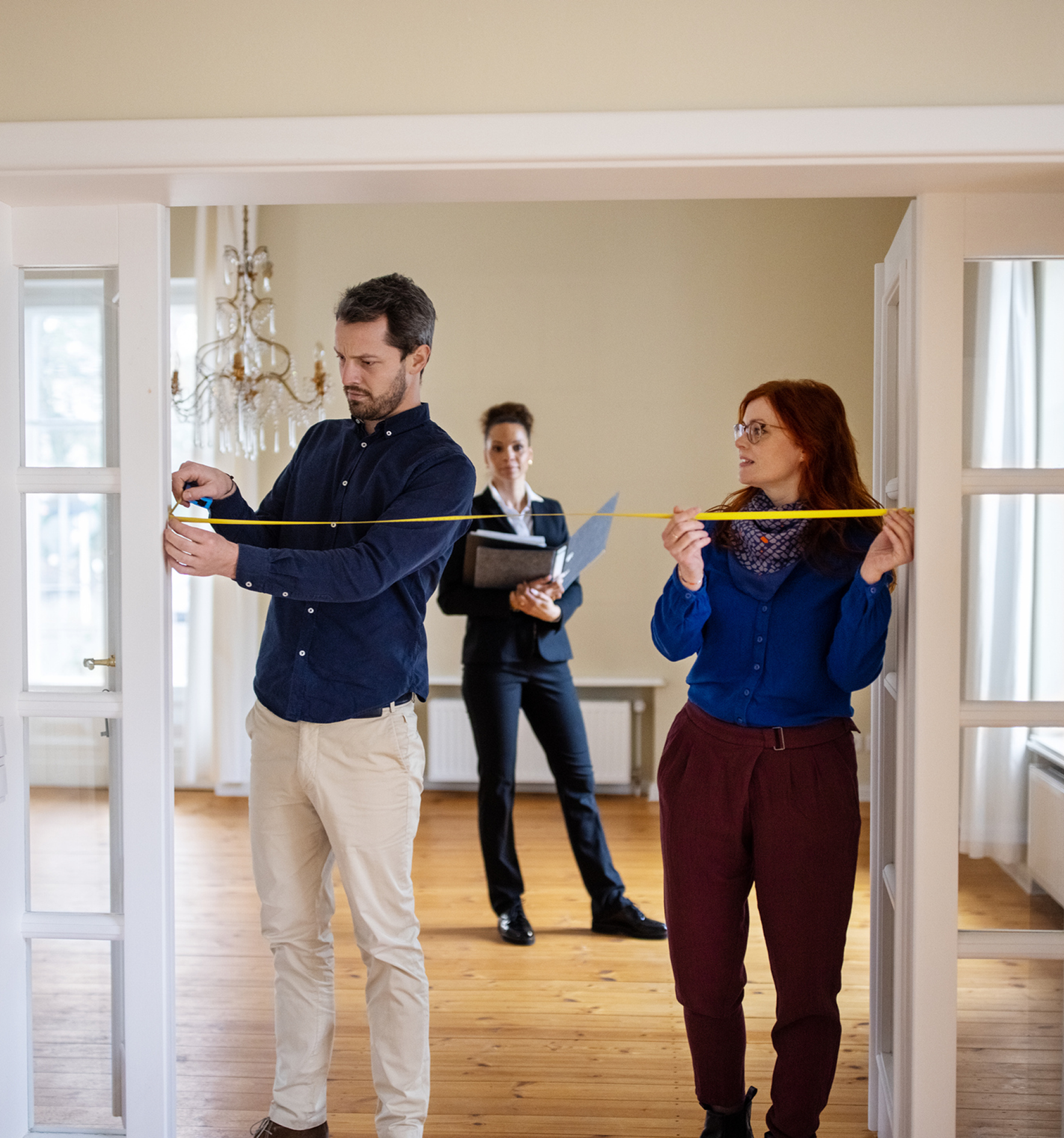 Three people in an empty room