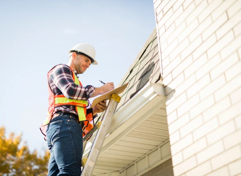 Roof inspection by worker